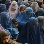 Young Afghan girls walking through a village amid concerns over rising child marriage