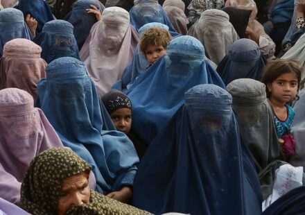 Young Afghan girls walking through a village amid concerns over rising child marriage