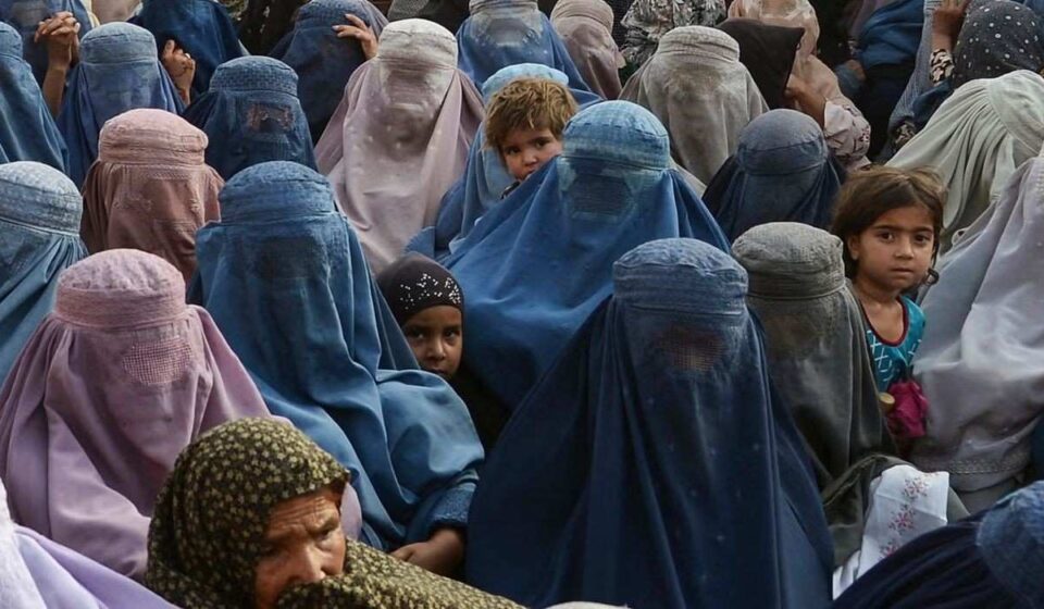 Young Afghan girls walking through a village amid concerns over rising child marriage