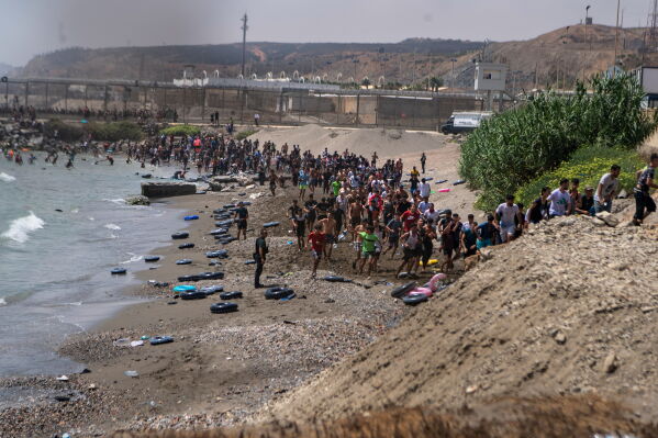 Large numbers of migrants entering the Spanish enclave of Ceuta as security forces respond