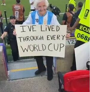 TikTok personality Gangster Granny holding a sign supporting Lionel Messi during a football match
