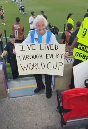 TikTok personality Gangster Granny holding a sign supporting Lionel Messi during a football match