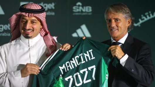Roberto Mancini gestures from the touchline while coaching Italy during an international football match.