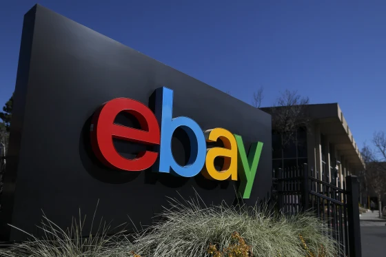 eBay logo with legal documents representing the company's $50 million cyberstalking settlement